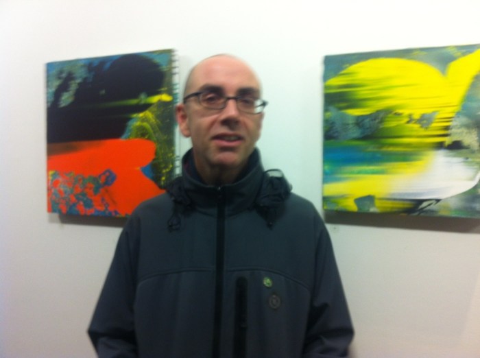 Elfyn Lewis in the middle of two of his works